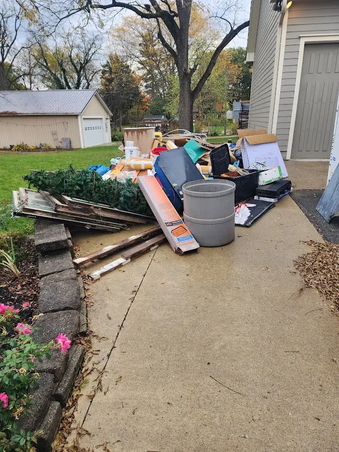 Dumpster being loaded with debris for Roofing Dumpster Rental in Wadena